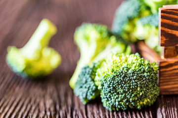 Fresh broccoli in wooden box on wooden surface