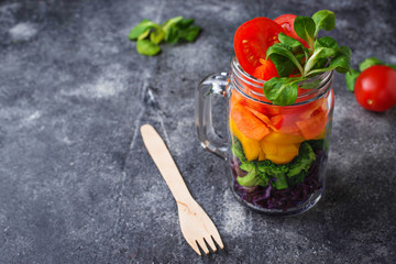 Vegetarian rainbow salad in a glass jar