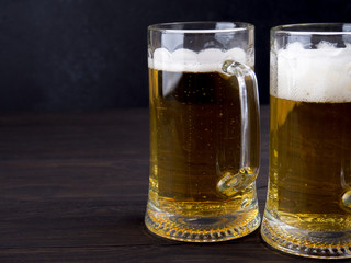 Two glasses of lager served on old wooden planks, copyspace for text