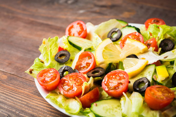 Closeup view of raw vegetarian mix salad with lemon juice