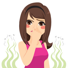 Young teenager girl pinching her nose bad stinking bad smell concept