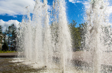 Water jets in the fountain in the sun