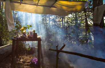 Campsite with smoke from the fire and in the morning sun