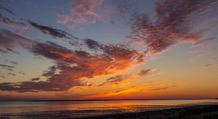 Obraz na płótnie Canvas A unique cloud of the golden sunset on the coast