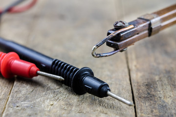 Accessories in the electronics workshop. Soldering iron, tin and other tools needed for repairs of electronic devices.