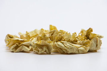 Crumpled yellow papers on white background 