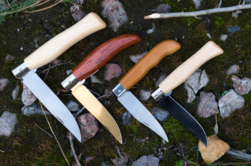 Knife with a wooden handle. Pocket knives. Many knives.