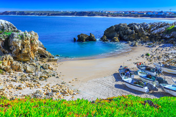 Wonderful romantic afternoon panoramic landscape. Coastline of island Baleal of the Atlantic ocean near Peniche. Fishing boat boats on the sandy shore on beach. West coast of Portugal at sunny weather
