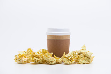 Take away coffee cup with crumpled papers on white background 