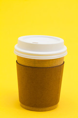 Take away coffee cup on the yellow background 