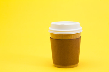 Take away coffee cup on the yellow background 