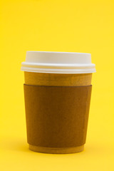Take away coffee cup on the yellow background 