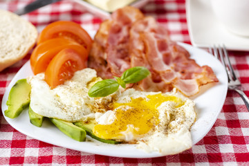 bacon and eggs with avocado and tomato, bread and coffee