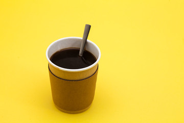 Black coffee in a paper take away coffee cup with spoon