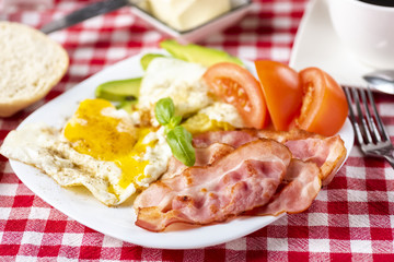 bacon and eggs with avocado and tomato, bread and coffee