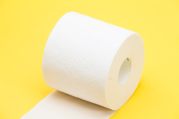 White toilet roll paper on yellow background