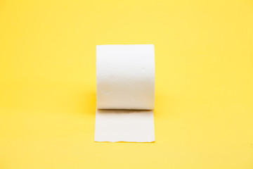 White toilet roll paper on yellow background
