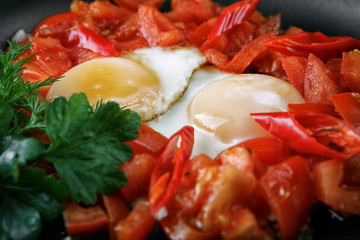 Fried eggs with tomatoes and bell peppers