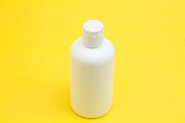 White bottle on the yellow background
