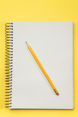 Study note book with yellow pencil 