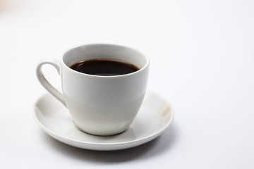A cup of black coffee on a white 