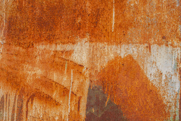 painted iron surface with a large rusty and metal corrosion, old background with peeling and cracking paint as background, orange texture