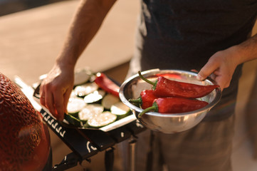 Man hands preparing fresh red pepper for grill