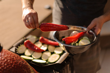Male hands preparing fresh vegetables for grill