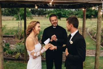 Bride and groom exchanging wedding vows on wedding ceremony - Powered by Adobe