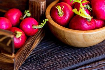 Fresh red radishes in wooden box close