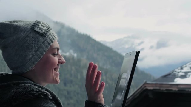 Young woman video chatting in the mountains, Alps, Austria