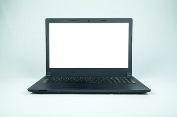 Black laptop computer with empty screen on gray background.