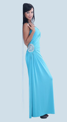 Beautiful woman in blue long dress posing on white background