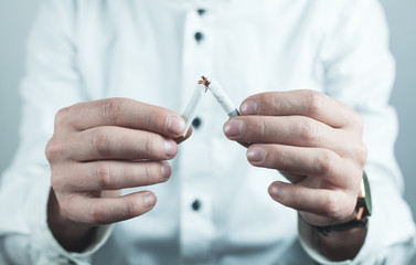 Man breaking a cigarette. Stop smoking.