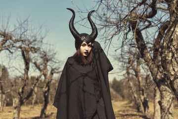 Brunette in a spring apple orchard