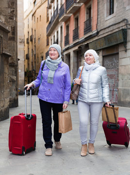 Senior ladies tourists walking around city