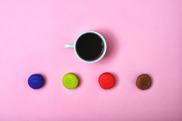 Colorful sweet macaroons and a cup of tea. Delicious breakfast. Top view.	