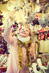 Obraz premium female on Christmas Fair looking on decoration
