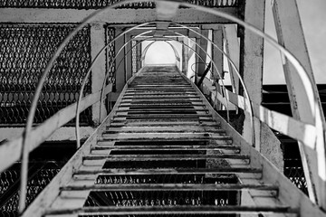 Black and white photo industrial metal staircase up