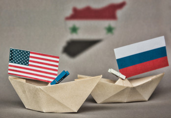 paper ship with Flags of USA and Russia. conflict in Syria sea, concept shipment or free trade...