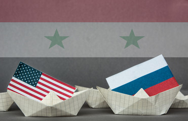 paper ship with Flags of USA and Russia. conflict in Syria sea, concept shipment or free trade...