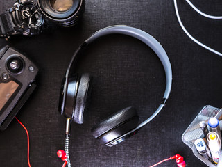 top down view of travel gadgets and accessories on the table with black surface