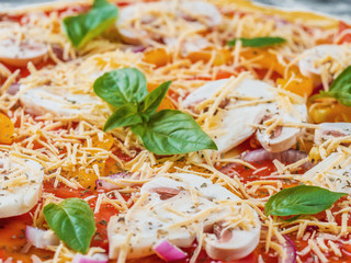 Italian pizza with melted mozzarella and tomato garnish with fresh basil on a thick crust. Food ingredients and spices for cooking mushrooms, cheese, onion, oil, pepper. Top view. Banner