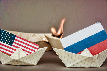 paper ship with Flags of USA and Russia. conflict in Syria sea, concept shipment or free trade...