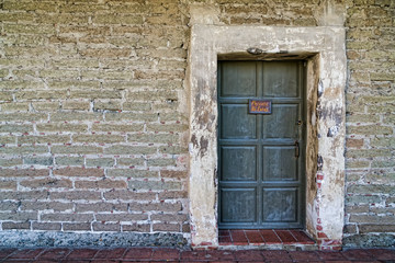 Fototapeta na wymiar Distressed Wall and Closed Door Backdrop