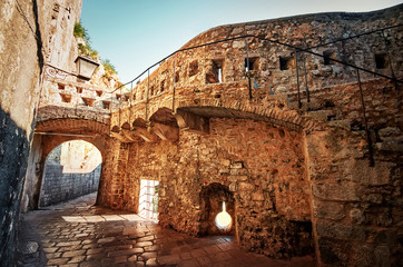 Fantastic view of the streets of the old city of Kotor. Ancient stone staircase erected along the...