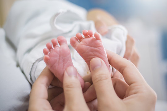 Close Up Father And Mother Hands Holding Newborn Baby Over Black Background, Copy Space Background Banner Family Parents Love Concept