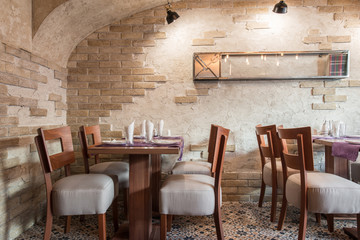Old vintage styled restaurant interior and setting tables