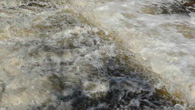 Flood of water floods. Burly and flowing muddy water. Spring flood.