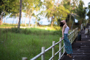 Fototapeta premium Fashionable girl of mixed race on an abandoned facility in the jungles of Asia.